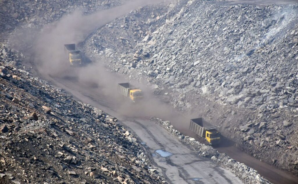 Vehicles and earthmovers enter in a coalmine during the nationwide COVID-19 lockdown