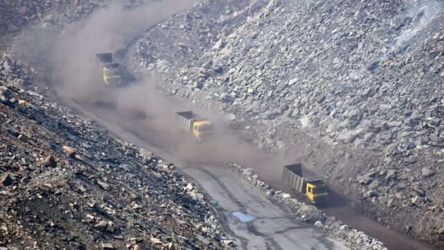 Vehicles and earthmovers enter in a coalmine during the nationwide COVID-19 lockdown